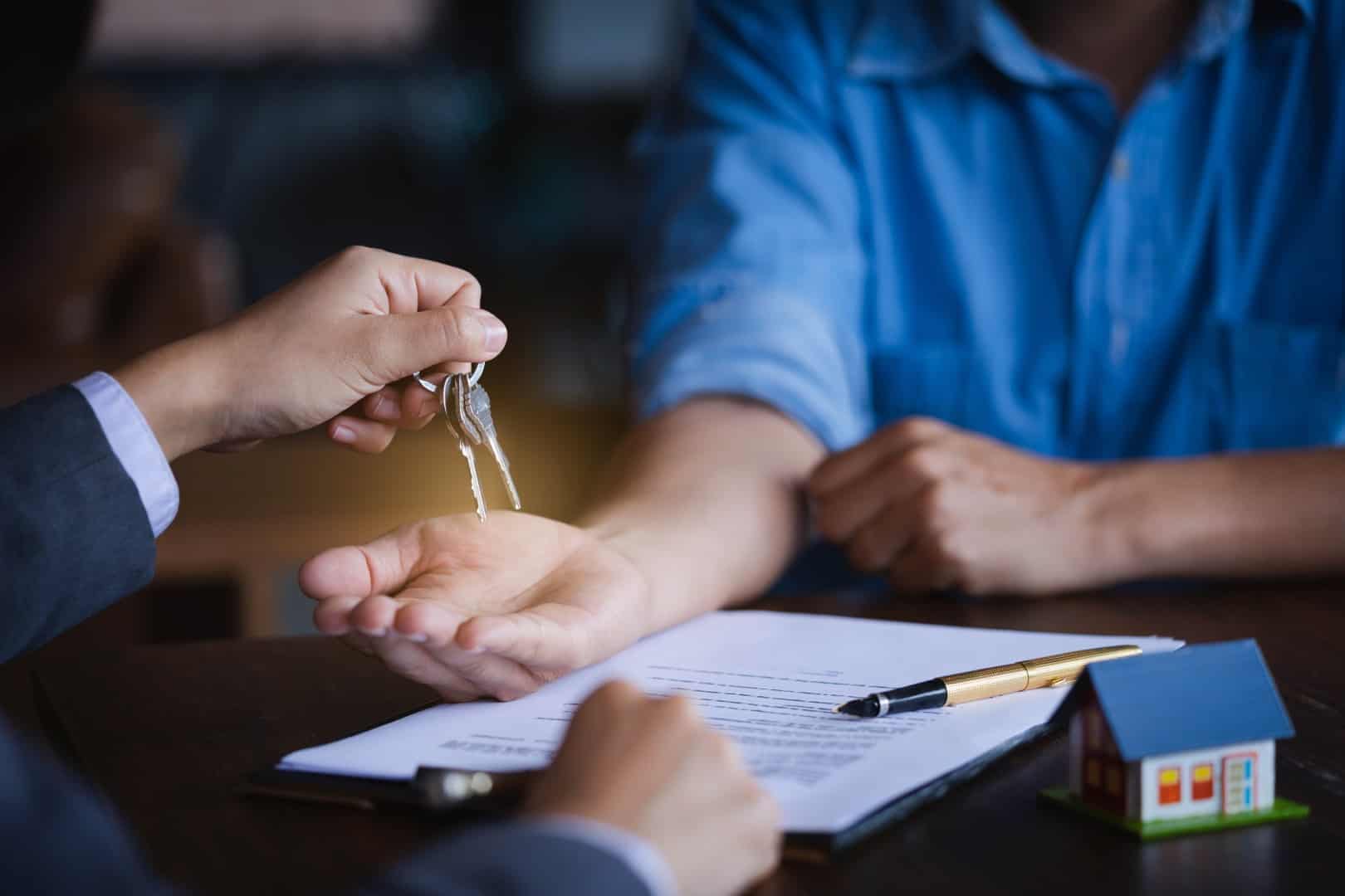 Real estate agent giving keys to new property owners after signing contract,concept agreement and Real estate concept.real estate, moving home or renting property.